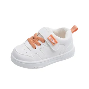 Comfortable white toddler sneakers featuring orange laces and non-slip soft soles for kids