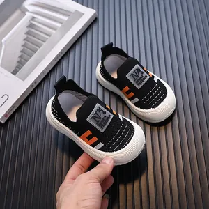 Breathable black fly-knit children's sports shoes with soft flexible soles for daily wear