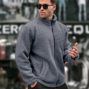 Close-up detail of a men's grey fuzzy sherpa jacket featuring a stand collar and full zipper