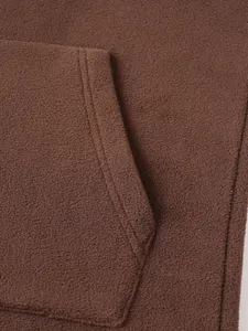 Close-up detail showing the soft brown fleece fabric and pocket on a casual men's sweatshirt