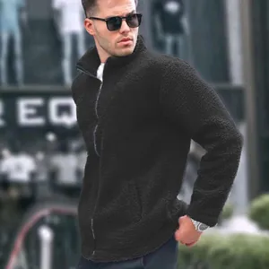 Close-up of men's black fleece jacket with stand collar and textured fabric detail.
