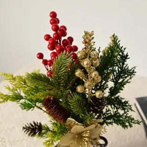 Close-up of festive Christmas floral bouquet with red berries and gold accents.