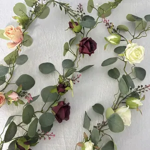 Close-up of realistic artificial rose and eucalyptus vine with detailed petals and leaves