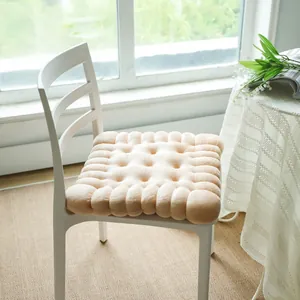 Biscuit-shaped plush seat cushion showing texture and thick padding on a chair