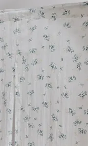 Detailed view showing the texture and vintage floral pattern of this white cotton door curtain