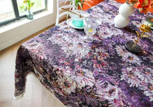 Detailed macro shot of thick purple floral woven tablecloth with elegant white fringe