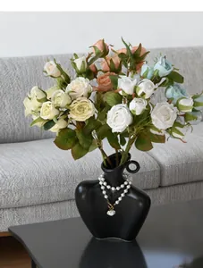 Detail of 8-head artificial oil-painted roses in an elegant black ceramic vase