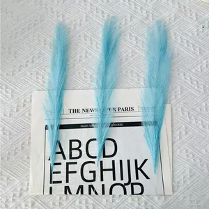 Close-up of three sky blue artificial pampas grass plumes for Nordic home decoration