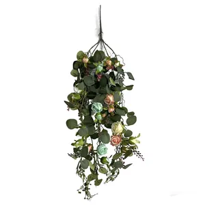 Full view of artificial French rose and eucalyptus hanging vine on white background.