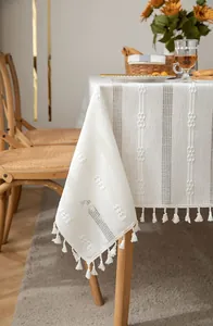 Close-up of a vintage white hollow embroidered cotton linen tablecloth with elegant tassels