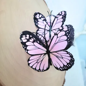 Detailed macro view of artificial pink monarch butterflies on a rustic wooden log