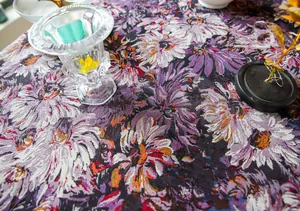 Macro detail of high-density purple floral woven tablecloth with thick jacquard texture