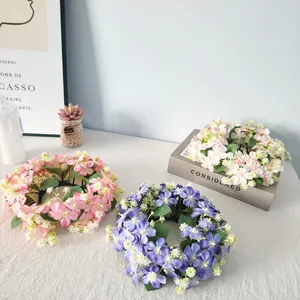 Close-up of colorful artificial wildflower wreaths for table and candle decoration.