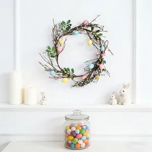 Pastel Easter egg and berry wreath with twig branches for spring wall decoration