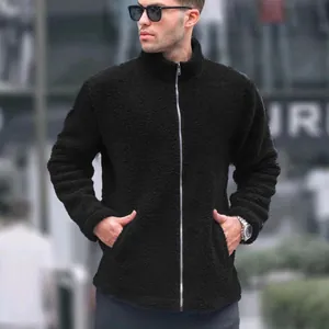Man wearing a premium black zip-up sherpa fleece jacket with a sleek stand collar