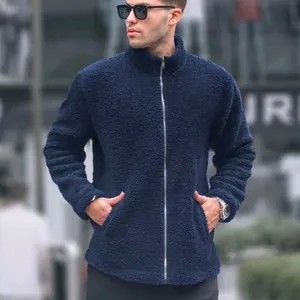 Detail view of men's navy blue fleece jacket with full zip and warm fuzzy texture.