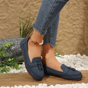 Close-up of navy blue women's tassel loafers with soft soles in a casual setting