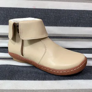 Side view of women's beige leather ankle boots with zipper and warm lining