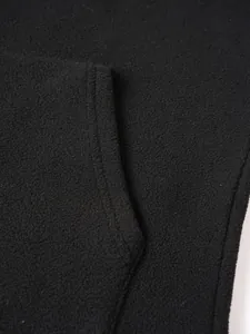Macro view of black fleece fabric texture and pocket stitching on casual sweatshirt
