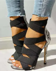 Detail showing elastic criss-cross straps and snakeskin pattern on stiletto heels