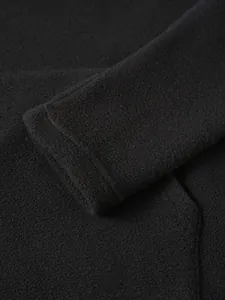 Detailed macro view of black polar fleece material and durable cuff stitching on sweatshirt