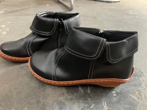 Black leather ankle boots with contrast white stitching and a stylish fold-over cuff design