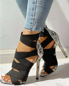 Detailed view of sexy Roman stilettos featuring black elastic straps and snakeskin print