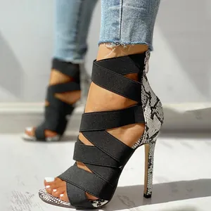 Sexy high-heeled sandals with black elastic straps and snake print stiletto heel design.