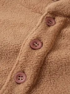 Close-up detail of brown fleece fabric and buttons on men's stand collar sweatshirt