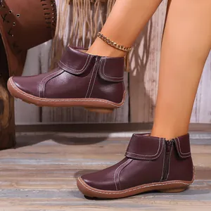 Stylish burgundy leather ankle boots for women featuring side zipper and white stitching detail