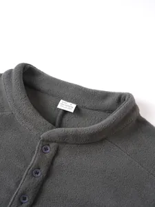 Close-up of the stand collar and soft fleece texture of a grey men's sweatshirt