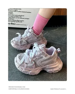 Close-up detail of children's pink metallic dad shoes with sparkling rhinestone accents.