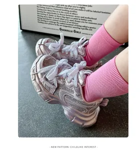 Close-up of kids pink metallic sneakers with sparkling rhinestone detail and thick sole