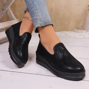 Close-up view of black textured platform loafers for women in a lifestyle setting
