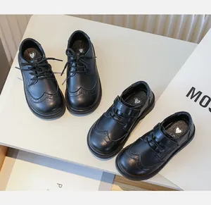 Detail view of boys' black leather dress shoes in lace-up and velcro styles