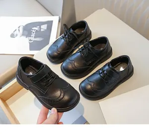 Detailed macro view of black British style leather dress shoes for boys with soft soles