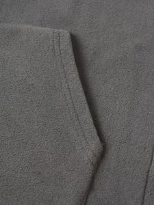 Detailed macro view showing the soft texture and seam of a grey fleece hoodie for men