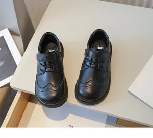 Detailed top view of boys' black British style brogue leather shoes with soft soles