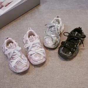 Detail view of children's rhinestone sneakers in pink, silver, and black colorways