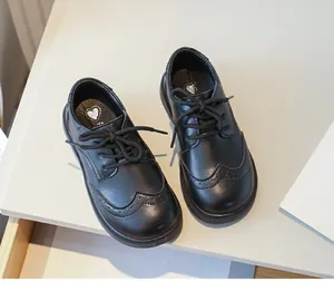 Classic boys' black leather Brogue shoes with wingtip detail for formal school events