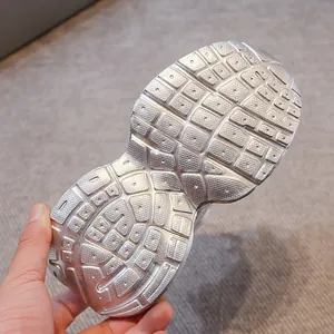 Detailed macro view of the non-slip silver textured outsole for children sneakers.