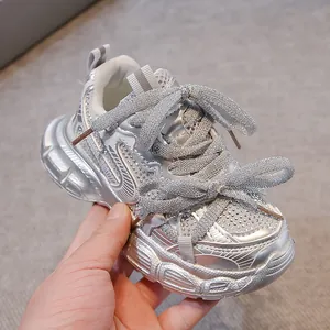 Detailed view of silver glitter children's sneakers with sparkling rhinestone accents.