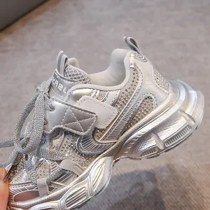 Detailed close-up of shiny silver rhinestone children's sneakers for jazz dance