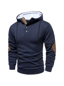 Macro view of navy blue textured fabric and button neck detail on men's heavyweight hooded sweatshirt