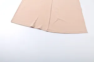 Vue détaillée de l'ourlet et des finitions de couture d'un vêtement uni à coupe ajustée.