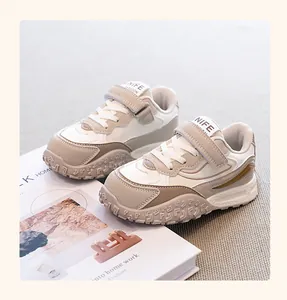 Close-up of stylish children's beige chunky sneakers with a textured durian sole
