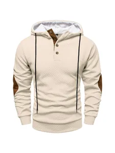 Detailed view of cream textured heavy hoodie with button-neck and elbow patches