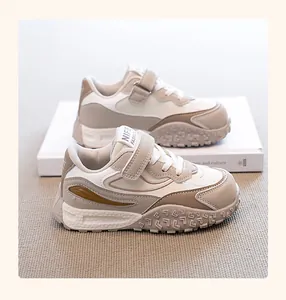 Detailed side view of stylish beige children's dad sneakers with non-slip soles