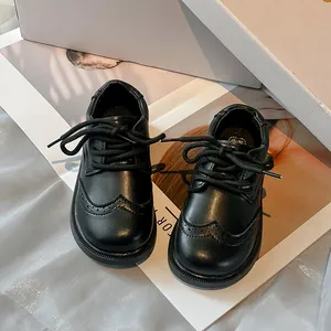 Classic boys' black Oxford shoes with British brogue detail and soft sole