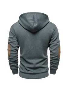 Detailed back view of a textured teal men's hoodie featuring brown contrast elbow patches